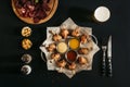 top view of delicious roasted chicken with various sauces on baking paper and glass of beer on black Royalty Free Stock Photo