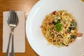 Delicious spicy spaghetti with bacon, dried chilli, basil and garlic with fork and spoon prepare side dish Royalty Free Stock Photo