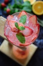 Top view of a delicious strawberry gin and tonic garnished with mint