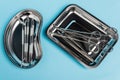 Top view of dental tools in stainless trays on blue background. Royalty Free Stock Photo