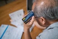 Top view of Depressed Senior Elderly male hold cradit card, feel worry about financial problem. Stressed old man look to paperwork Royalty Free Stock Photo