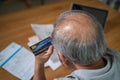 Top view of Depressed Senior Elderly male hold credit card, feel worry about financial problem. Stressed old man look to paperwork Royalty Free Stock Photo