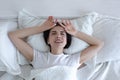 Top view, depressed woman lying in bed crying and screaming with sadness