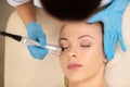 Top view of dermatologist doing under eye skin treatment