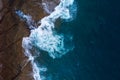 Top view of a deserted coast. Rocky shore of the island of Tenerife. Aerial drone photo of ocean waves reaching shore Royalty Free Stock Photo