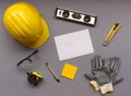 top view design engineering and construction concept on grey background with tools, white paper, safety helmet, gloves, pencil, Royalty Free Stock Photo