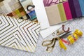 Top view of designer`s worplace.Notebook,pen, measuring tape, samples of fabrics for furniture,scissors,thread,thimble Royalty Free Stock Photo