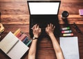 Top view.Designer in Scottish shirt, Graphic creative holding Mouse pen and working on laptop in office,Sunset background, Royalty Free Stock Photo