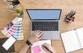 Top view of designer using laptop on desk at office Royalty Free Stock Photo