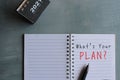 Top view of desk calendar and notebook with text WHAT`S YOUR PLAN Royalty Free Stock Photo