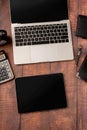 Top view desktop blank tablet, laptop and stationery on wooden background Royalty Free Stock Photo