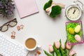 Top view of the desktop. Cup of coffee glasses keyboard alarm clock flowers with easter decorations. Flat lay copy space Royalty Free Stock Photo