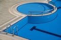 Top view detail of pool with blue water and entrance with chrome grab bars