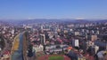 Top view of developed city on the background of mountainous landscape. Clip. Beautiful panorama of large city in valley