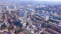 Top view of developed city on the background of mountainous landscape. Clip. Beautiful panorama of large city in valley