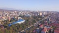 Top view of developed city on the background of mountainous landscape. Clip. Beautiful panorama of large city in valley