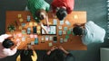 Top view of developer team working together to write idea on note. Convocation. Royalty Free Stock Photo
