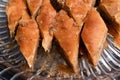 Top view of diamond shape homemade Turkish baklava in a glass plate. Baklava with walnut. Cevizli baklava in Turkish Royalty Free Stock Photo