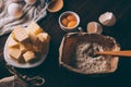 Top view of diced butter, sack of flour, raw yolks