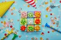 Top view of different colorful gifts with bows, party hats and confetti