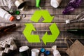 Top view of Different garbage materials with recycling symbol on table background. Recycle, environment and Eco concept Royalty Free Stock Photo