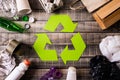 Top view of Different garbage materials with recycling symbol on table background. Recycle, environment and Eco concept Royalty Free Stock Photo