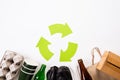 Top view of Different garbage materials with recycling symbol on white wooden table background. Recycle, World Environment Day and Royalty Free Stock Photo