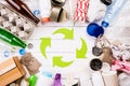 Top view of Different garbage materials with recycling symbol on white wooden table background. Recycle, World Environment Day and Royalty Free Stock Photo