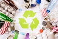 Top view of Different garbage materials with recycling symbol on white wooden table background. Recycle, World Environment Day and Royalty Free Stock Photo