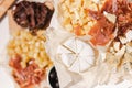 Top view of different kinds of cheese and meat on table