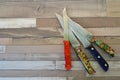 Top view of different knifes on rustic wooden tabletop, with copy space