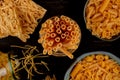 top view of different types of macaroni as bucatini spaghetti tagliatelle and others on wooden background