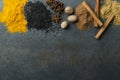 Top view of different types of spices. Cinnamon, turmeric, star anise, nutmeg, black sesamum n the rustic grey table.Empty spce fo Royalty Free Stock Photo