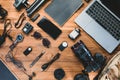 Top view with a digital camera, charger, camera, lens, video camera, USB, personal laptop, book, pen, glasses, remote control, and Royalty Free Stock Photo