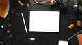 Top view of tablet, camera, coffee cup and photographer accessories on black leather. Royalty Free Stock Photo