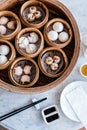 Top view of Dim sum set: Barbecued pork bun, Shrimp dumpling, Sweet cream buns, Shrimp shumai topping with goji berry. Royalty Free Stock Photo