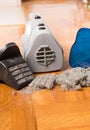 Open handheld vacuum cleaner with filter and dirt on floor Royalty Free Stock Photo