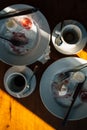 Top view dirty dishes after cake and coffee for two. Candid photo table cafe with leftovers of lunch, crumpled napkins, forks, Royalty Free Stock Photo