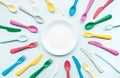 Top view of dish with colorful spoon and fork element on color table Royalty Free Stock Photo