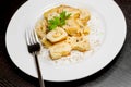 Top of view of dish of italian swivels pasta with porcini mushrooms and sauce bechamel with pepper near fork Royalty Free Stock Photo