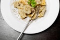 Top of view of dish of italian swivels pasta with porcini mushrooms and sauce bechamel with pepper near fork Royalty Free Stock Photo