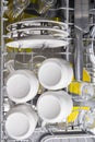 Top view, in the dishwasher, clean dishes, mugs, plates and metal appliances