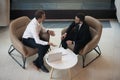 Top view diverse businessmen talking seated on armchair indoors