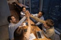 Top view diverse colleagues giving high five, celebrating business achievement Royalty Free Stock Photo