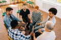 Top view of diverse and different ages people holding hands sitting in circle. Top view group therapy and business Royalty Free Stock Photo