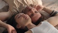 Top view of diverse young gay couple lying on bed Royalty Free Stock Photo