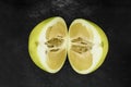 Top view of divided in the half pomelo fruit and placed on black stone background surface Royalty Free Stock Photo