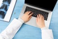 Top view of doctor hands typing at laptop Royalty Free Stock Photo
