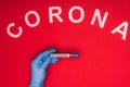 Top view of doctor holding test tube with blood sample and corona lettering