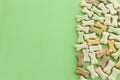 Top view of dog treats over green wooden background